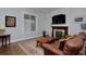 Cozy living room with a stone fireplace, hardwood floors, and a comfortable sofa at 482 S Logan St, Denver, CO 80209