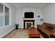 Cozy living room with a stone fireplace, hardwood floors, and a comfortable sofa at 482 S Logan St, Denver, CO 80209