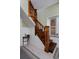 Classic wood staircase with detailed trim and adjacent window adding natural light to the entry at 482 S Logan St, Denver, CO 80209