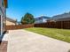 A spacious backyard with a concrete patio and a grass area enclosed by a wooden fence at 5572 Kalispell St, Denver, CO 80239