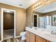 Bathroom featuring double sinks, vanity, and a separate room for the shower at 5572 Kalispell St, Denver, CO 80239