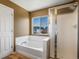Bathroom featuring a soaking tub and a glass-enclosed shower at 5572 Kalispell St, Denver, CO 80239