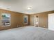 Bedroom with neutral walls, carpeted floors, and a door leading to a bathroom at 5572 Kalispell St, Denver, CO 80239