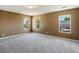 Spacious bedroom with neutral walls, carpeting, and natural light from three windows at 5572 Kalispell St, Denver, CO 80239