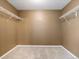 Empty walk-in closet with beige carpet and wire shelving on the walls at 5572 Kalispell St, Denver, CO 80239