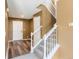 Bright foyer with staircase, wood-style flooring, and coat closet at 5572 Kalispell St, Denver, CO 80239