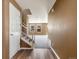 Inviting home foyer with wood floors, staircase, and an open floor plan at 5572 Kalispell St, Denver, CO 80239