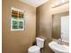 Well-lit half bath with a pedestal sink and a window at 5572 Kalispell St, Denver, CO 80239