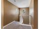 Bright hallway with natural light from windows and staircase with white railing at 5572 Kalispell St, Denver, CO 80239
