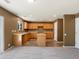 Functional kitchen with light wood cabinets, an island, and modern flooring at 5572 Kalispell St, Denver, CO 80239