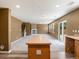 Open concept kitchen and living room with island, fireplace, and sliding glass doors at 5572 Kalispell St, Denver, CO 80239