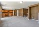 Open concept living space with adjoining kitchen and staircase at 5572 Kalispell St, Denver, CO 80239