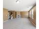 Spacious living room with plush carpet, fireplace, and large windows offering ample natural light at 5572 Kalispell St, Denver, CO 80239