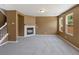 Cozy living room featuring a fireplace, large windows, and staircase at 5572 Kalispell St, Denver, CO 80239