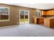 Inviting living room with sliding glass doors leading to the backyard and bright natural lighting at 5572 Kalispell St, Denver, CO 80239