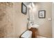A cozy bathroom featuring a sink, toilet, and decorative elements at 2838 Decatur St, Denver, CO 80211