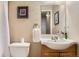 A cozy bathroom featuring a sink, toilet, and decorative elements at 2838 Decatur St, Denver, CO 80211