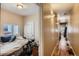 Bedroom with a twin bed and view into a hallway with tan walls and hardwood floors at 2838 Decatur St, Denver, CO 80211