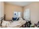 A bedroom featuring a comfortably made bed, natural light, and functional decor at 2838 Decatur St, Denver, CO 80211