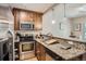 Well-equipped kitchen with granite countertops, wooden cabinets, and stainless steel appliances at 2838 Decatur St, Denver, CO 80211