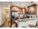 Well-lit kitchen featuring stainless steel appliances, granite countertops, and wood cabinetry at 2838 Decatur St, Denver, CO 80211