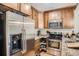Efficient kitchen with stainless steel appliances and wooden cabinets at 2838 Decatur St, Denver, CO 80211