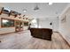 Bright living room with skylights, wood floors, a comfortable sofa, and doors leading to outdoor scenic views at 31762 Horseshoe Dr, Evergreen, CO 80439