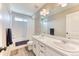 Bright bathroom boasts double sinks, large mirror, and shower over tub with tiled surround at 6307 Saddle Bow Ave, Parker, CO 80134
