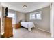 Neutral bedroom with soft carpet, window with shade, dresser and twin bed at 6307 Saddle Bow Ave, Parker, CO 80134