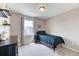 Comfortable bedroom features a window, soft carpet, and neutral walls at 6307 Saddle Bow Ave, Parker, CO 80134