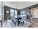 The open dining room offers an elegant dining table set and a neutral color scheme at 6307 Saddle Bow Ave, Parker, CO 80134
