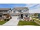 Charming two-story home with stone accents, a well-manicured lawn, and attached two car garage at 6307 Saddle Bow Ave, Parker, CO 80134