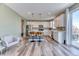 Bright kitchen with white cabinets, stainless steel appliances, and hardwood floors at 6307 Saddle Bow Ave, Parker, CO 80134