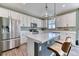 The open kitchen includes an island with seating, quartz countertop and modern appliances at 6307 Saddle Bow Ave, Parker, CO 80134