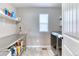 Functional laundry room with stainless steel appliances, ample shelving, and utility sink at 6307 Saddle Bow Ave, Parker, CO 80134