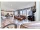 Cozy living room featuring a leather sofa set, media center, and access to kitchen at 6307 Saddle Bow Ave, Parker, CO 80134