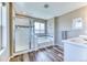 Bright main bathroom with a glass-enclosed shower, soaking tub, modern vanity, and great natural light at 6307 Saddle Bow Ave, Parker, CO 80134
