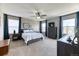 Serene main bedroom with large windows, soft carpeting, and stylish furnishings with great natural light at 6307 Saddle Bow Ave, Parker, CO 80134