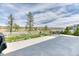 Concrete patio with table and chairs, overlooking a large grassy field and walking path at 6307 Saddle Bow Ave, Parker, CO 80134