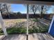 Spacious backyard with healthy green grass and a wood fence, viewed from a covered outdoor porch at 530 Hickory St, Hudson, CO 80642