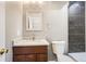 Stylish bathroom featuring a granite countertop vanity, modern fixtures, and a black marble-tiled shower and white toilet at 530 Hickory St, Hudson, CO 80642
