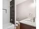 Modern bathroom with a shower and granite vanity, offering contemporary style and comfort at 530 Hickory St, Hudson, CO 80642