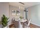 Cozy dining room with stylish light fixture, round table, and hardwood floors at 530 Hickory St, Hudson, CO 80642