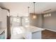 Open kitchen with a granite island, stainless steel appliances, and an adjacent dining area at 530 Hickory St, Hudson, CO 80642