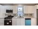 Well-equipped kitchen with white cabinetry, stainless steel appliances, and a tile backsplash at 530 Hickory St, Hudson, CO 80642