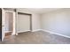 Spacious living room with new carpet, gray walls, and hardwood hallway at 530 Hickory St, Hudson, CO 80642