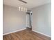 Empty living room space featuring hardwood floors, neutral walls, and ample natural light at 530 Hickory St, Hudson, CO 80642