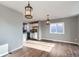 Open-concept living room with hardwood floors, seamlessly connecting to a kitchen with stainless steel appliances and white cabinetry at 530 Hickory St, Hudson, CO 80642