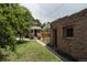 The backyard includes a charming brick outbuilding, grassy lawn, garden and patio area at 461 S Sherman St, Denver, CO 80209