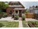 A cozy backyard with a small patio, garden beds, and a well-kept lawn area at 461 S Sherman St, Denver, CO 80209